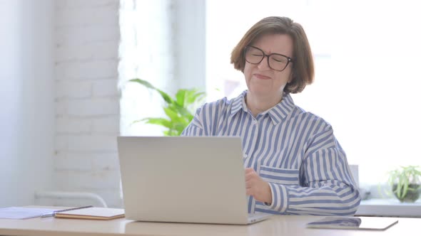 Senior Woman Having Back Pain While Using Laptop