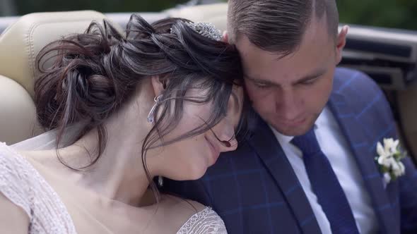 Pretty Bride Leans on Fiance in Car Slow Motion Close View