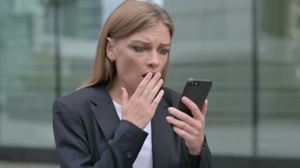Businesswoman Having Loss While Using Smartphone