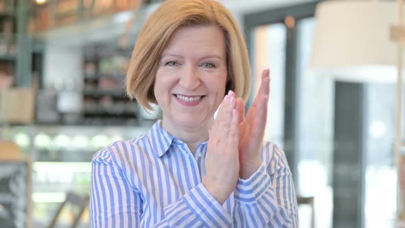 Portrait of Appreciative Creative Old Woman Clapping