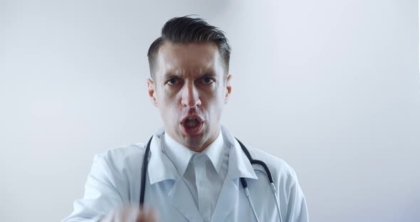 Closeup of Angry Doctor Scolding and Shouting at Employees Threatening with a Finger and Shouting