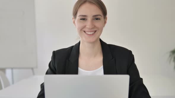 Close up of Smiling Young Businesswoman in Office