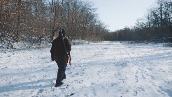 Hunter Walking in the Snowy Winter Forest, Winter Hobby, Sun, Hunting Concept