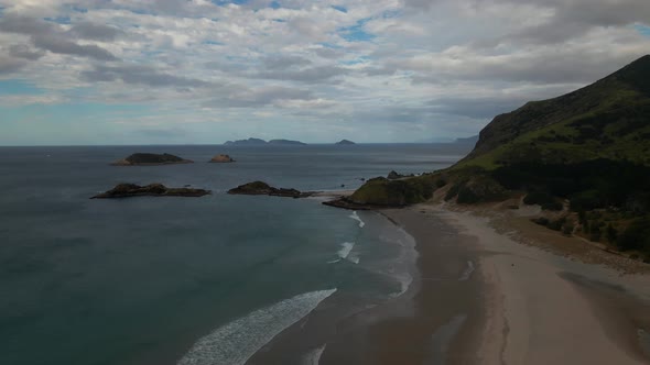 Beautiful Whangarei Heads Ocean Beach in New Zealand on a cloudy day -aerial