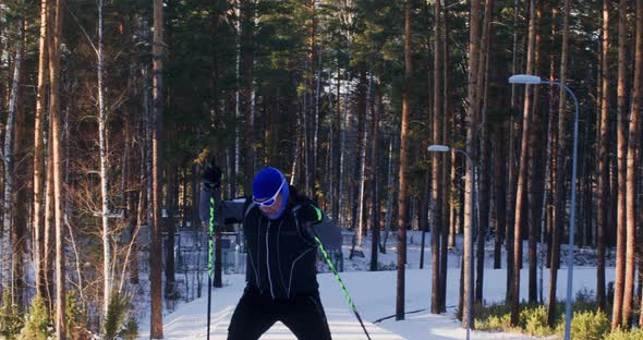 Sportive Man Skying Through Snowy Winter Woodland