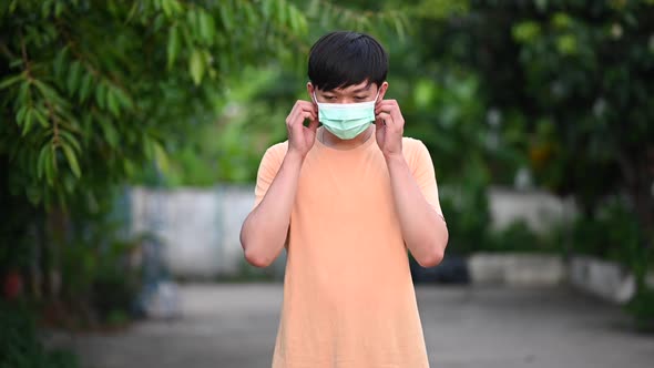 4K footage of a young boy taking off a mask and smiling.