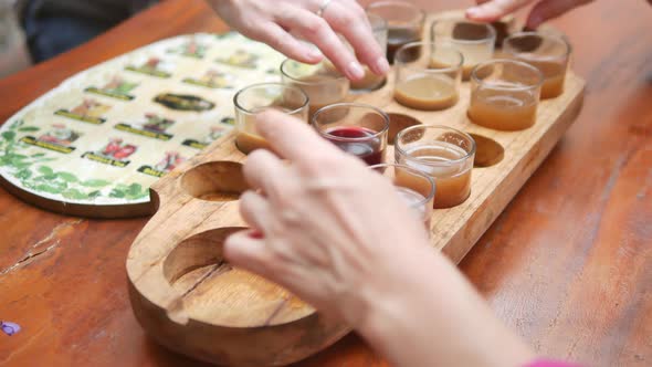 Closeup View of Tourists Hands and Tray with Various Coffee and Tea Drinks at Kopi Luwak Farm During