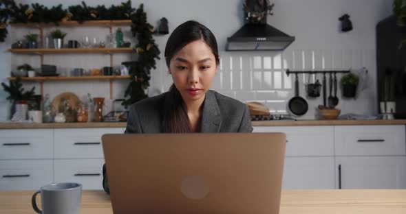 Asian Business Woman Use Laptop and Work From Home in the Evening on Holidays