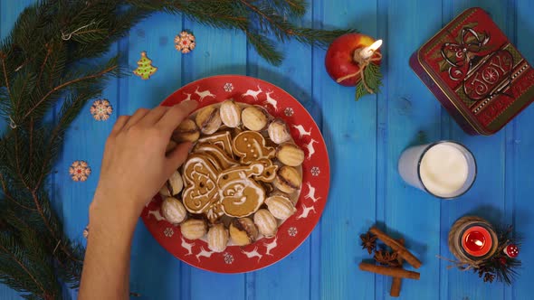Taking Christmas cookies from a plate