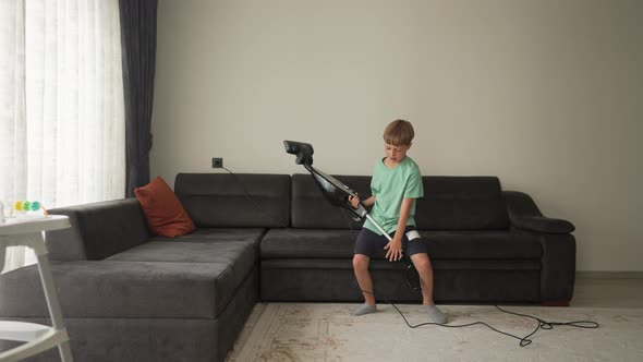 Nine Year Boy Having Fun While Cleaning