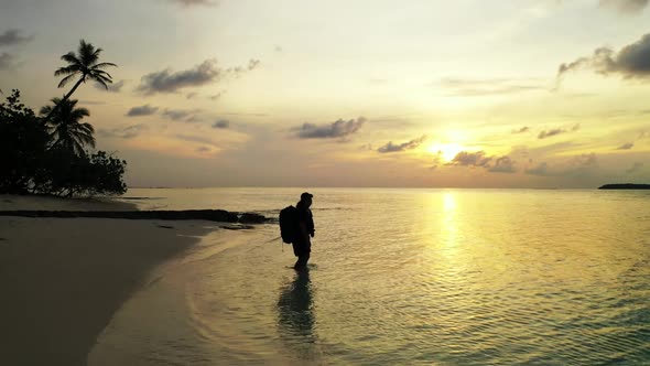 Single female posing on tropical shore beach voyage by blue ocean with clean sand background of the 