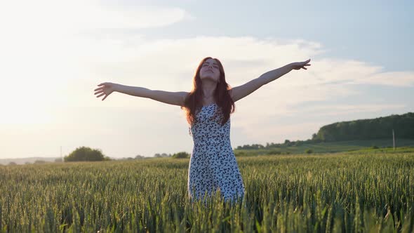 Natural Beauty Ginger Woman is Enjoying Beautiful Nature on Green Field