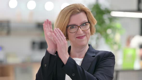 Portrait of Appreciative Old Businesswoman Clapping 