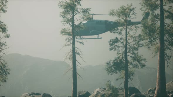 Extreme Slow Motion Flying Helicopter Near Mountain Forest