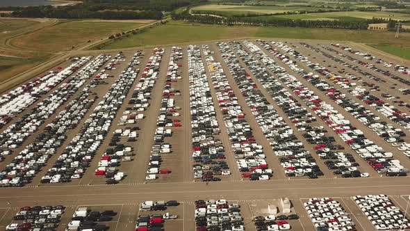 Many new and occasion Cars on a huge parking lot waiting for shipment, Aerial