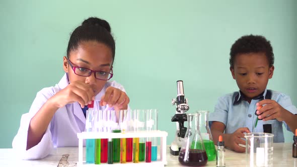 Two African American Mixed Kids Testing Chemistry Lab Experiment