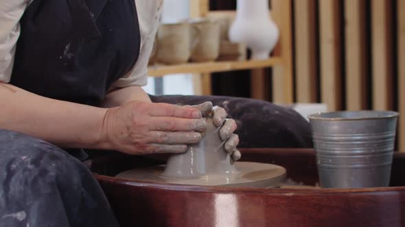 Pottery  Shaping Wet Piece of Clay on Pottery Wheel