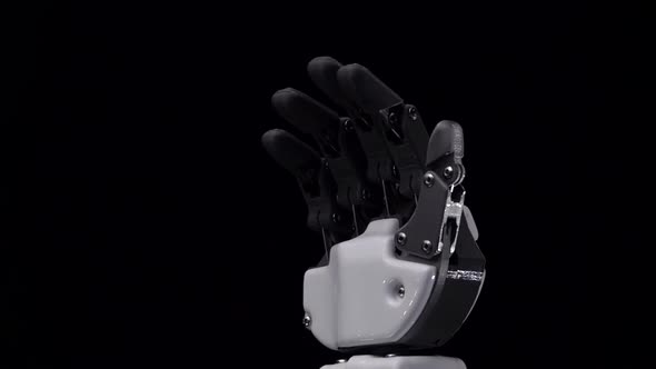 Robot Hand Close Up Waving Goodbye . Black Background. Close Up. Slow Motion