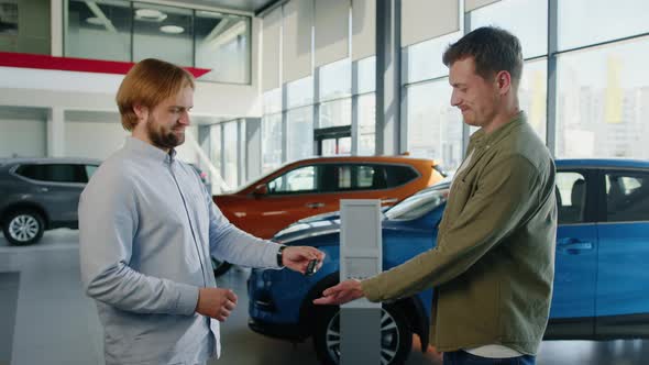 The Manager Gives the Man the Keys to the Bought Car