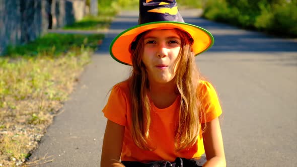 Child Girl in Costume Celebrates Halloween