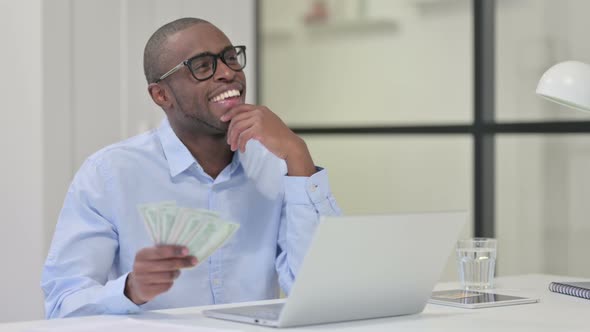 African Man Counting Dollars Work