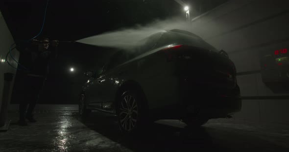 The Guy Is Washing the Car at the Selfservice Car Wash