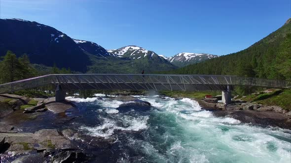 Girl on the bridge watching waterfall