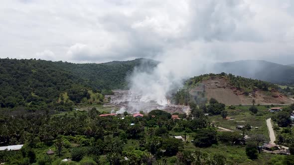 Clouds of smoke billowing from rubbish, trash and garbage being burned at the landfill tip in rural