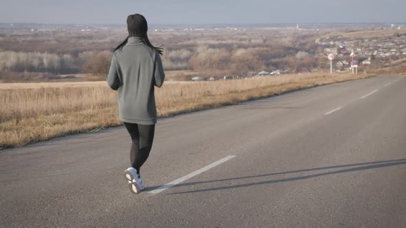 Young Fitness Woman Runner Athlete Running at Road