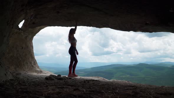 Girl Traveler Walks Through Cavern. Cave City in Vicinity of Bakhchisarai - Tope Kermen in Crimea