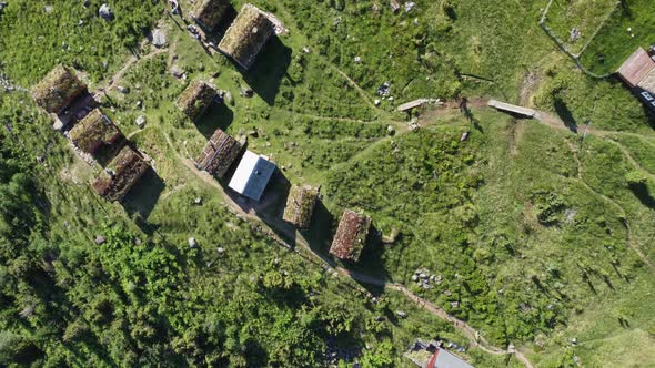 Raksetra Loen Nordfjord - Aerial top-down view showing cottages with grass covered rooftops and unre