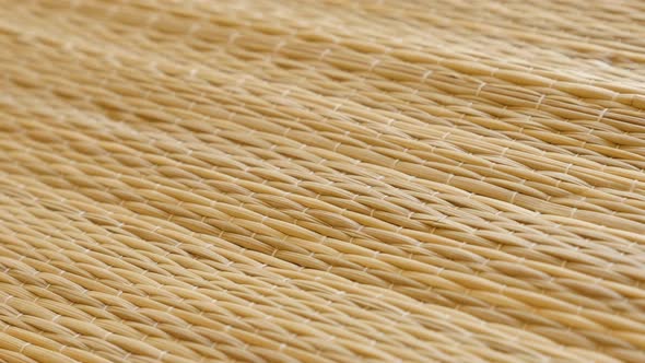 Handmade dried straw beach mat details slow pan 4K footage