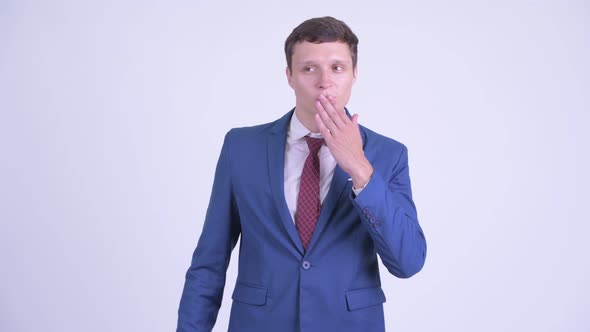 Happy Young Handsome Businessman Blowing Kiss