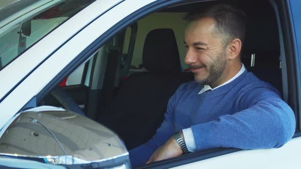 Happy Man Enjoys Buying a New Car