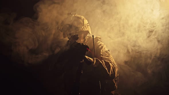 Silhouette of Special Forces Operator in Full Protection Gear with Assault Rifle