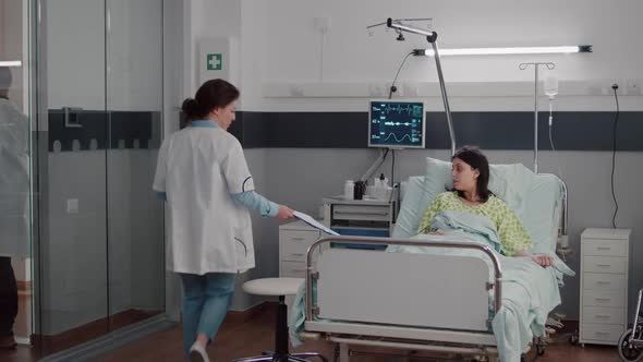 Female Doctor Monitoring Sick Woman During Rehabilitation Appointment