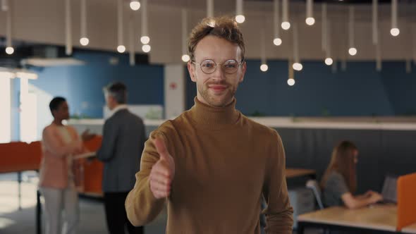 Portrait of Successful Caucasian Stylish Man Looking at Camera and Stretching Hand for Greeting