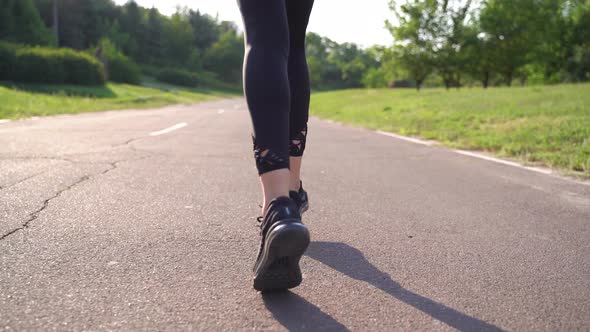 Close Up Young Fitness Woman Legs Walking at Road
