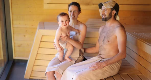 Young Family with a Little Boy in Sauna