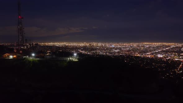 AERIAL HYPER LAPSE Over Hollywood Sign at Night in Los Angeles California at Night with Glowing