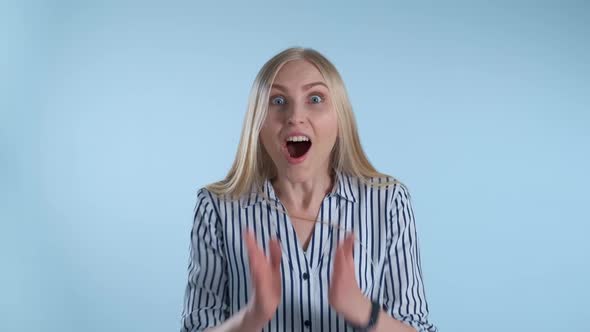 Blonde Female Widely Opening Her Mouth in Astonishment