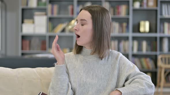 Portrait of Sleepy Young Woman Yawning