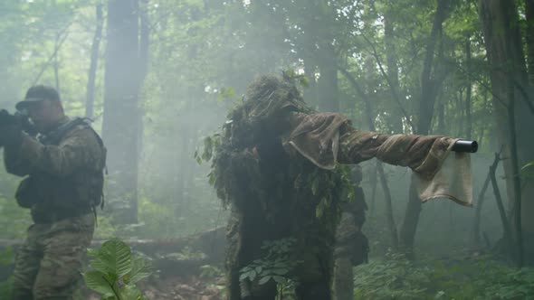 Counterterrorist Special Forces Group Wading Thicket of Forest in Fog