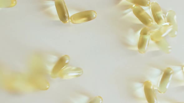 Omega 3 Capsules Falling on Table