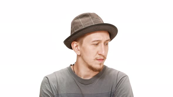 Upset Young Handsome Man in Hat Thinking Over White Background