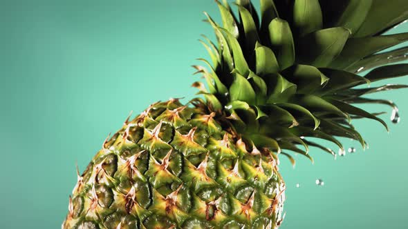 Super Slow Motion Water Drips on Rotating Pineapple