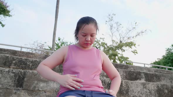 Unhappy boring overwieght of young sport Asian fat woman serious with belly stomach