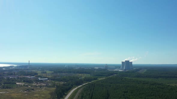 Smoking Cooling Towers at Nuclear Power Plant in Forest. Aerial View