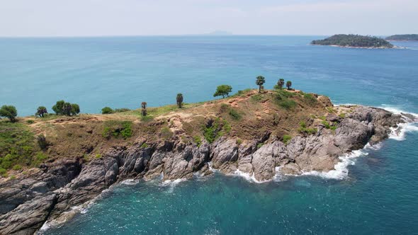 Drone camera top down of seashore rocks in a blue ocean Turquoise sea surface Amazing sea waves