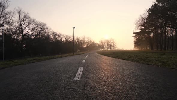 Empty Road in Suburbia on Sunrise Sunlight, Cinematic Low Angle View.